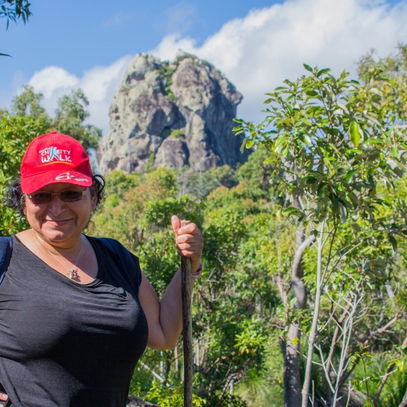 a man standing next to a tree