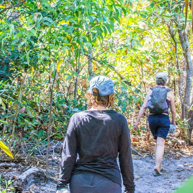 a man standing next to a tree