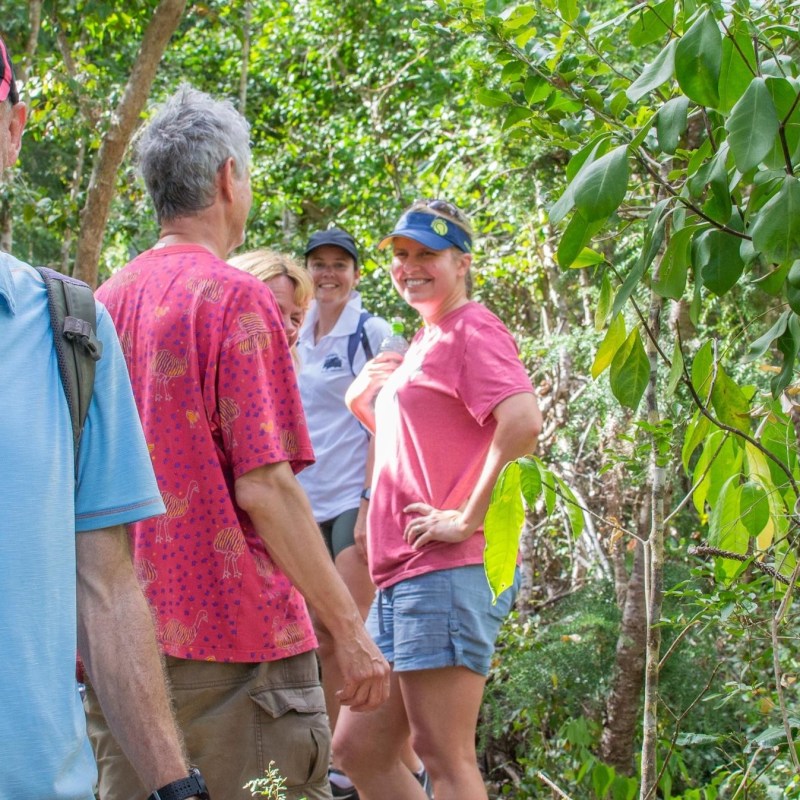 a man standing next to a tree