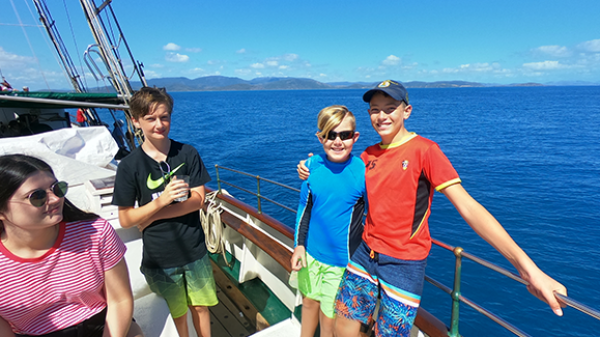 a group of people standing next to a body of water
