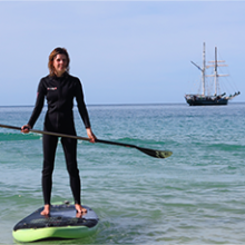 a man standing next to a body of water