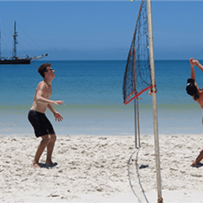 a person standing on top of a sandy beach