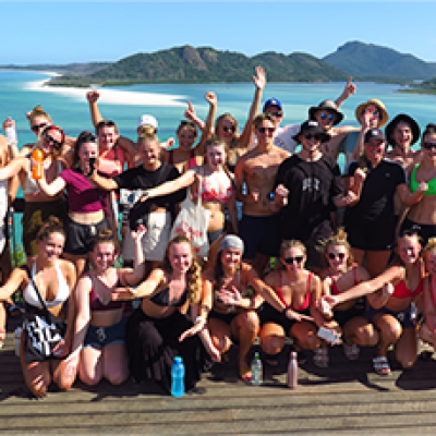 a group of people standing in front of a crowd posing for the camera