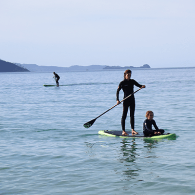 a group of people riding skis on a body of water