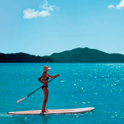 a person riding a surf board on a body of water
