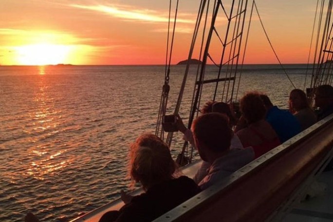 a man sitting in a boat on a body of water
