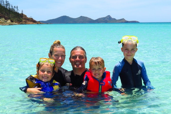 a child swimming in a body of water