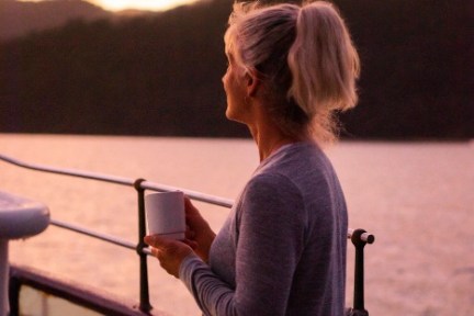 a person standing in front of a sunset