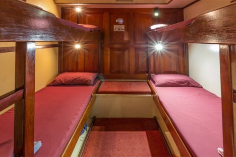 a bedroom with a bed and a chair in a room