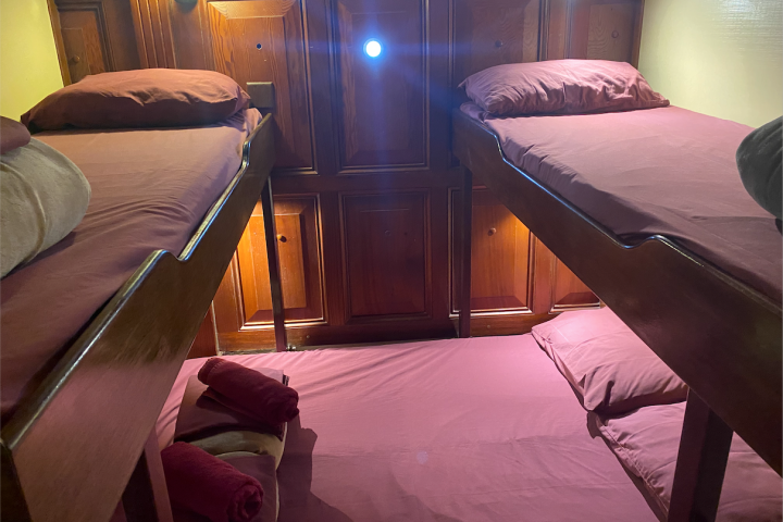 a bedroom with a bed and a chair in a room