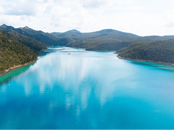a body of water with a mountain in the background